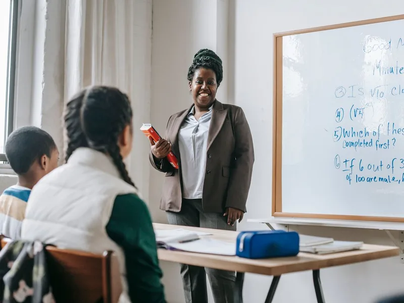 A teacher mentoring students in a classroom